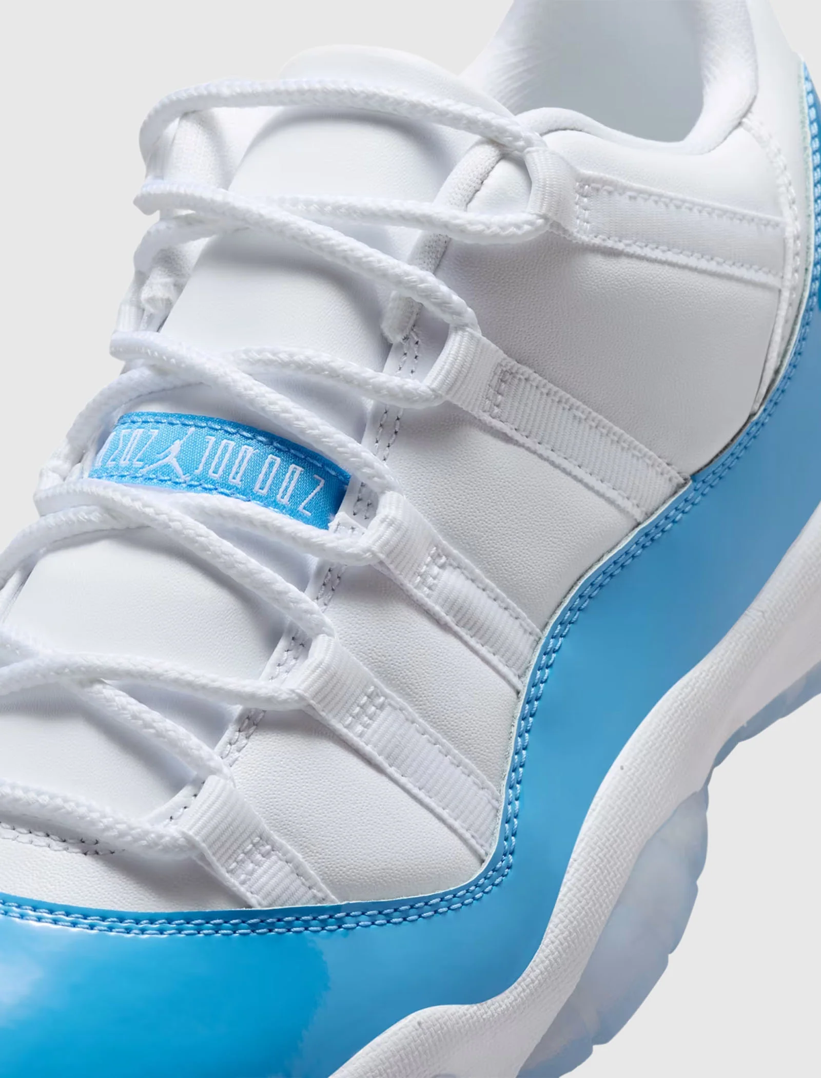 AIR JORDAN 11 RETRO LOW "WHITE/UNIVERSITY BLUE/BLACK" - Image 2